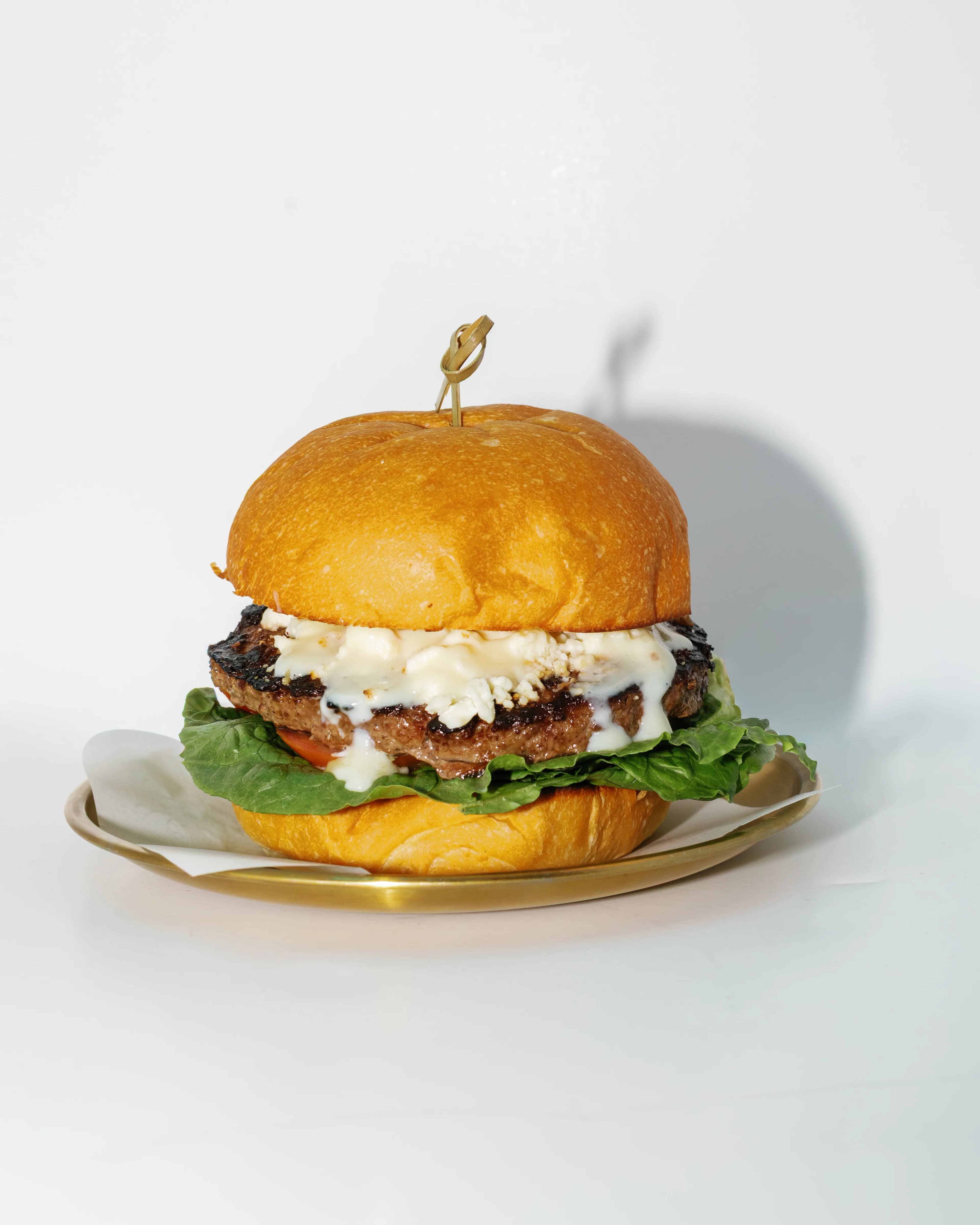 Blue cheese burger with caramelized onions and crumbled bleu cheese on a brioche bun at Darling Aviary rooftop restaurant in Downtown Sacramento