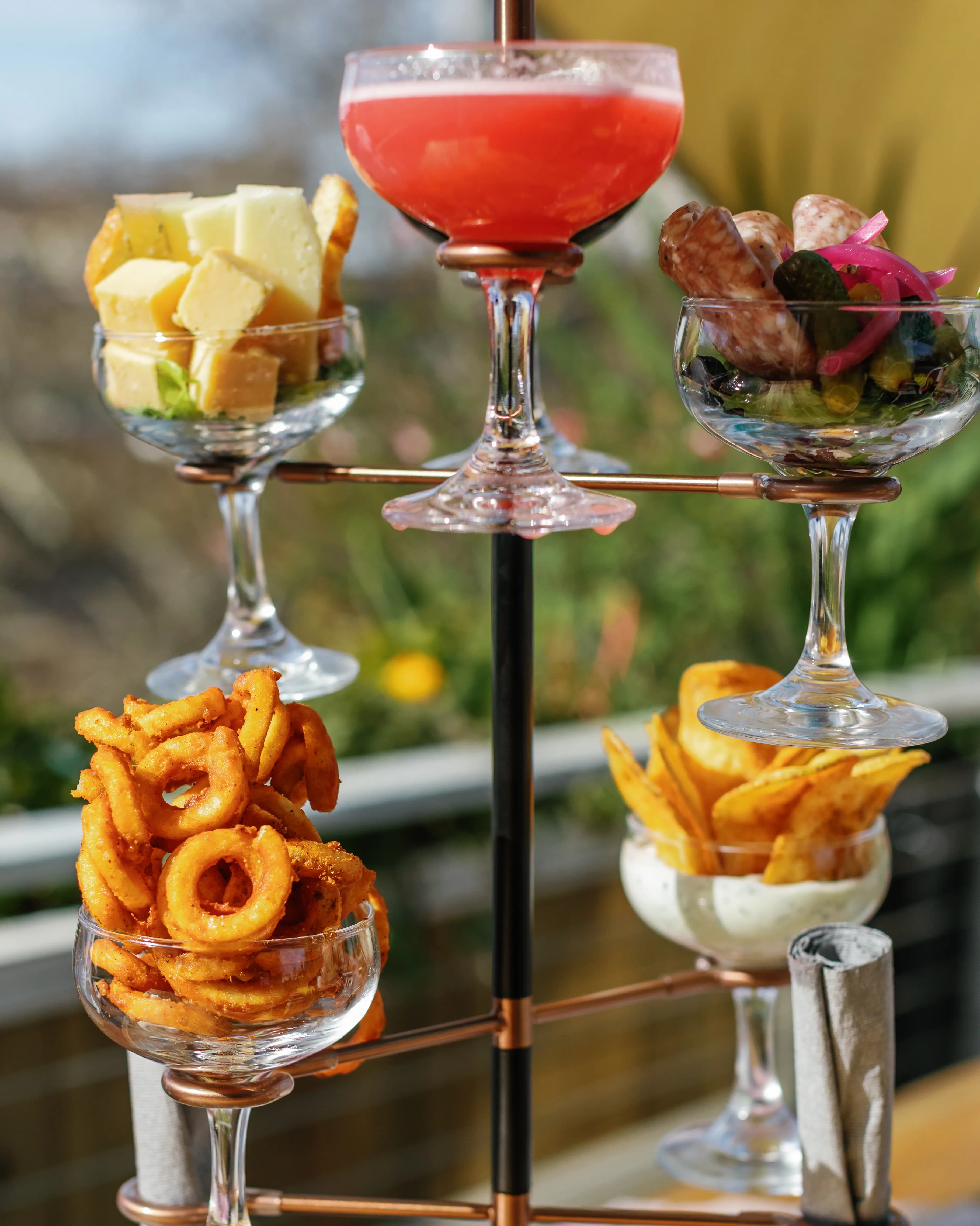 Tiered cocktail snack tower with handcrafted drinks, charcuterie and shareable bites at Darling Aviary rooftop bar — 712 K Street in DoCo, Downtown Sacramento
