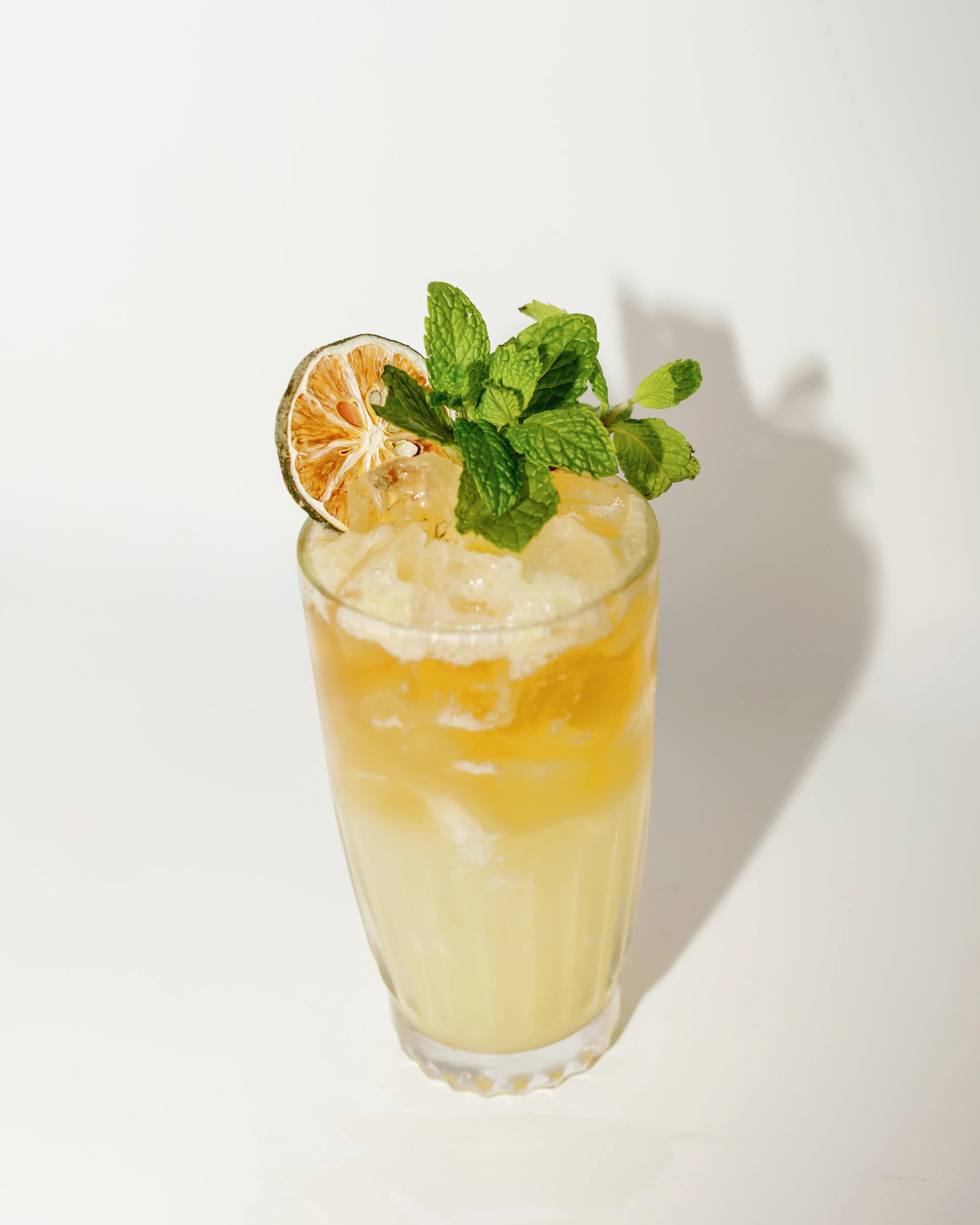 Pineapple mint highball cocktail with fresh mint and pineapple garnish at Darling Aviary rooftop bar, Downtown Sacramento